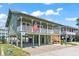 Charming two-story home with a spacious porch and a well-manicured lawn at 161 Easy St., Garden City Beach, SC 29576