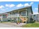 Charming raised beach house with a large front porch and classic coastal architecture at 161 Easy St., Garden City Beach, SC 29576