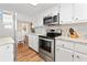 Kitchen featuring stainless steel appliances, white cabinets and granite countertops at 161 Easy St., Garden City Beach, SC 29576