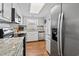 Bright kitchen with granite counters, stainless steel appliances, hardwood floors, and ample storage at 161 Easy St., Garden City Beach, SC 29576