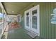 Inviting porch with rocking chairs, offering a relaxing outdoor space with coastal charm at 161 Easy St., Garden City Beach, SC 29576