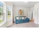 A versatile bonus room featuring a comfortable blue couch and a picturesque window at 1620 San Andres Ave., Little River, SC 29566