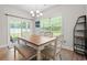 Inviting dining room featuring a wood table, bench seating, and a view of the outdoor patio at 1620 San Andres Ave., Little River, SC 29566
