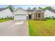 Charming home with a well-kept lawn, brick accents, and an attached two-car garage at 1620 San Andres Ave., Little River, SC 29566