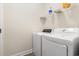 Bright laundry room with white washer and dryer units and a shelf for supplies at 1620 San Andres Ave., Little River, SC 29566