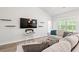 Cozy living room featuring a large TV, floating shelves, and a comfortable sectional sofa at 1620 San Andres Ave., Little River, SC 29566