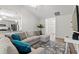 Open-concept living room with stylish sectional sofa, vaulted ceilings, and modern decor at 1620 San Andres Ave., Little River, SC 29566
