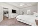 Bright bedroom featuring views to the kitchen and living area, a tray ceiling and soft carpeted floors at 1620 San Andres Ave., Little River, SC 29566