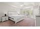 Bright main bedroom with white furniture, tray ceilings, and ample natural light from large windows at 1620 San Andres Ave., Little River, SC 29566