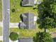 An aerial view of a home features a well-maintained roof, patio, yard, and driveway at 176 Whispering Oaks Dr., Longs, SC 29568