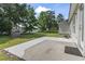 Backyard featuring a concrete patio, green grass, some trees and a white fence at 176 Whispering Oaks Dr., Longs, SC 29568