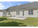 Exterior image of the house featuring a concrete patio with a door and windows at 176 Whispering Oaks Dr., Longs, SC 29568