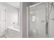 Bright bathroom features a glass shower, white door, and pink walls at 176 Whispering Oaks Dr., Longs, SC 29568