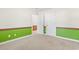 Neutral carpeted bedroom with green accent paint, white walls, and white trim at 176 Whispering Oaks Dr., Longs, SC 29568