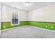 Empty bedroom with neutral carpet and green accent paint along the bottom of the wall at 176 Whispering Oaks Dr., Longs, SC 29568