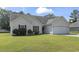 Charming home featuring a two-car garage, manicured lawn, red shutters, and a cozy front entrance at 176 Whispering Oaks Dr., Longs, SC 29568