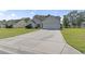 Charming home featuring a two-car garage, manicured lawn, red shutters, and a spacious driveway at 176 Whispering Oaks Dr., Longs, SC 29568