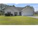 Charming home featuring a two-car garage, manicured lawn, red shutters, and a cozy front entrance at 176 Whispering Oaks Dr., Longs, SC 29568