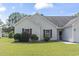 Charming home featuring a two-car garage, manicured lawn, red shutters, and a cozy front entrance at 176 Whispering Oaks Dr., Longs, SC 29568