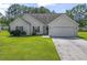Charming one-story home featuring a well-manicured lawn, attached two-car garage, and inviting front entrance at 176 Whispering Oaks Dr., Longs, SC 29568
