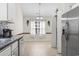 Bright eat-in kitchen featuring stainless steel appliances and neutral tile flooring at 176 Whispering Oaks Dr., Longs, SC 29568