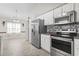 Well-lit kitchen featuring stainless steel appliances, white cabinets and breakfast nook at 176 Whispering Oaks Dr., Longs, SC 29568
