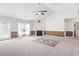 Bright and spacious living room with large windows, fireplace, and adjacent laundry room at 176 Whispering Oaks Dr., Longs, SC 29568