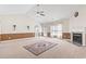 Expansive living room featuring a fireplace, neutral carpet, vaulted ceilings, and natural light from adjacent windows at 176 Whispering Oaks Dr., Longs, SC 29568