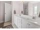 Main bathroom featuring double sink vanity with white cabinetry and private shower at 176 Whispering Oaks Dr., Longs, SC 29568