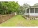 Lush backyard featuring a wooden fence, shed, and covered porch perfect for outdoor living and entertaining at 18 Pine Valley Ln., Surfside Beach, SC 29575