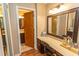 Bathroom with vanity, framed mirror, and wood trim open to a second bathroom with shower and commode at 18 Pine Valley Ln., Surfside Beach, SC 29575