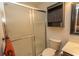 Bathroom with a sliding glass shower door, toilet, and wall storage at 18 Pine Valley Ln., Surfside Beach, SC 29575