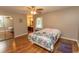 Comfortable bedroom with hardwood floors, ceiling fan, a closet with mirrored doors, and a queen size bed at 18 Pine Valley Ln., Surfside Beach, SC 29575