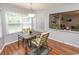 Cozy dining area with natural light, modern lighting, and a view into the living room at 18 Pine Valley Ln., Surfside Beach, SC 29575