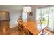 Bright dining room featuring hardwood floors, wooden furniture and abundant natural light from large windows at 18 Pine Valley Ln., Surfside Beach, SC 29575