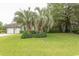 Charming brick home with a well-manicured front lawn and mature palm trees, creating a welcoming curb appeal at 18 Pine Valley Ln., Surfside Beach, SC 29575