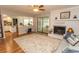 Cozy living room with a fireplace, ceiling fan, and sliding glass doors leading to an outdoor area at 18 Pine Valley Ln., Surfside Beach, SC 29575
