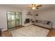 Inviting living room featuring a brick fireplace, a comfortable sofa, and sliding glass doors at 18 Pine Valley Ln., Surfside Beach, SC 29575
