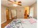 A spacious bedroom with hardwood floors, ceiling fan, and a full-length mirrored closet at 18 Pine Valley Ln., Surfside Beach, SC 29575