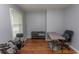 Bright office space with hardwood floors, desk, shelving, and workout bicycle, ideal for working from home at 18 Pine Valley Ln., Surfside Beach, SC 29575
