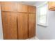 Functional storage with wooden cabinets and a window for natural light at 18 Pine Valley Ln., Surfside Beach, SC 29575