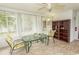A sun room with lots of natural light, a ceiling fan, and a glass table at 18 Pine Valley Ln., Surfside Beach, SC 29575