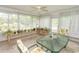 A sun room featuring many windows, plants, tile flooring, and a glass table at 18 Pine Valley Ln., Surfside Beach, SC 29575