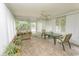 Bright sunroom featuring ample windows, plant life, and a comfortable seating area at 18 Pine Valley Ln., Surfside Beach, SC 29575