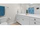 Bright bathroom featuring dual sinks, white cabinets, framed mirror, and modern fixtures at 186 Ella Kinley Circle # 101, Myrtle Beach, SC 29588