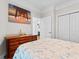 Bedroom showcasing a beach-themed art above a wooden dresser with a double door closet at 186 Ella Kinley Circle # 101, Myrtle Beach, SC 29588