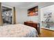 Comfortable bedroom with a window view and coastal artwork above a wooden dresser at 186 Ella Kinley Circle # 101, Myrtle Beach, SC 29588