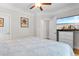 Spacious bedroom with ceiling fan, natural light, TV, and access to ensuite bathroom at 186 Ella Kinley Circle # 101, Myrtle Beach, SC 29588