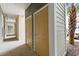 Apartment hallway showcasing doors and a view of a palm tree and parking at 186 Ella Kinley Circle # 101, Myrtle Beach, SC 29588