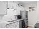 Modern kitchen featuring stainless steel appliances, granite countertops, and white cabinetry at 186 Ella Kinley Circle # 101, Myrtle Beach, SC 29588